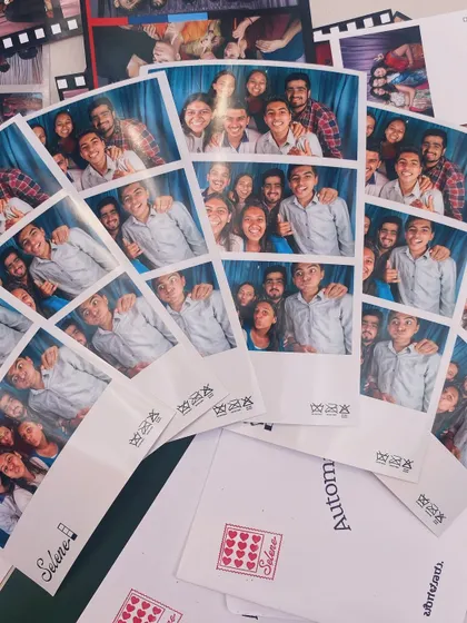 A pile of photo strips and custom envelopes, ready to be taken home as cherished memories.