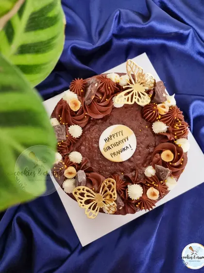 My Triple Chocolate Ganache Brownie Cake is pure indulgence. This 7-inch walnut brownie cake is decorated with different chocolate piping styles and delicate golden butterflies.