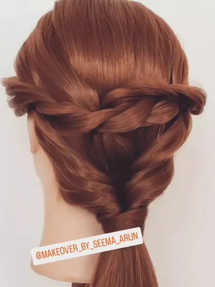 A simple and elegant half-up hairstyle. This look features a twisted braid across the back, leading into a loose ponytail, keeping hair away from the face while still showing off its length.