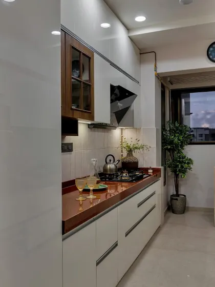 The kitchen is the heart of the home. This space features a bold red countertop, white cabinetry, and warm wood accents, creating a kitchen that is both practical and full of personality.