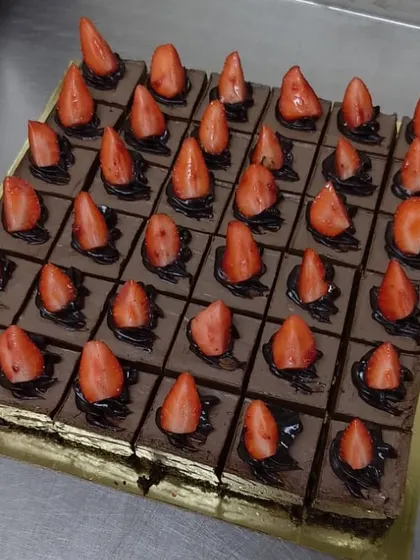 Our chocolate strawberry dessert, sliced and ready to serve. Each square is a perfect portion of fudgy, fruity goodness.
