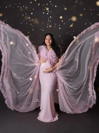 A magical edit adds a touch of sparkle to this angelic wing portrait. I love getting creative in post-production to bring your fairy-tale maternity photo ideas to life.