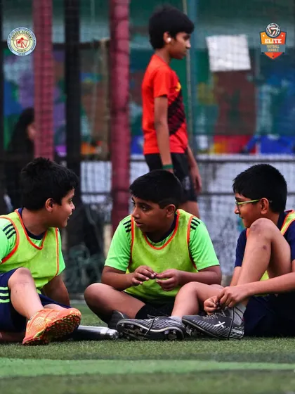 Young players in a discussion during a break. Learning the game involves strategy and communication.