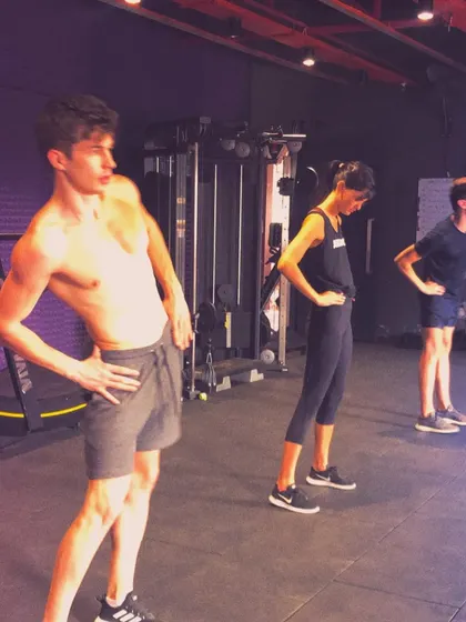 A group of clients working on their hip mobility and core stability. Proper warm-ups and activation drills are a key part of every training session to prepare the body for the work ahead.