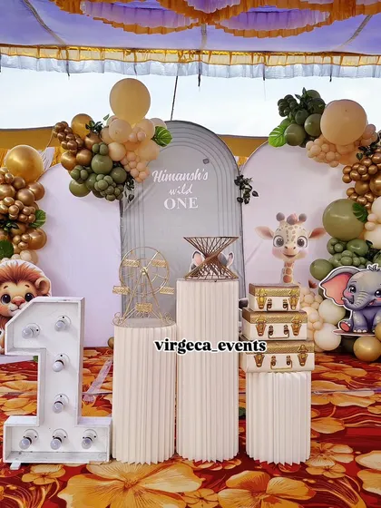 A boho-style 'Wild One' jungle theme. The muted green and gold balloons, along with cute animal characters, create a soft and stylish look.