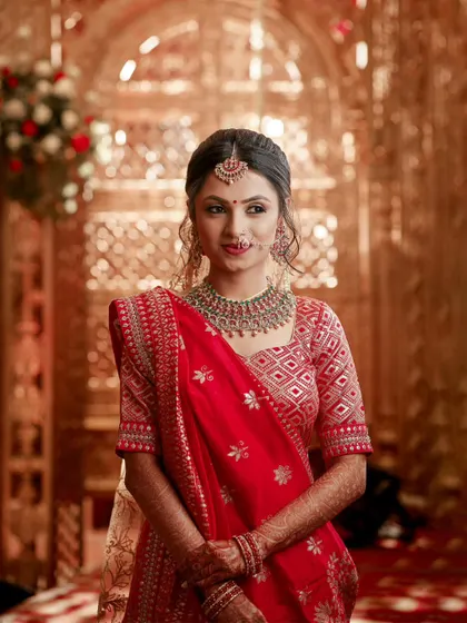 A classic bridal portrait against a golden, ornate background, highlighting the bride's radiant look.