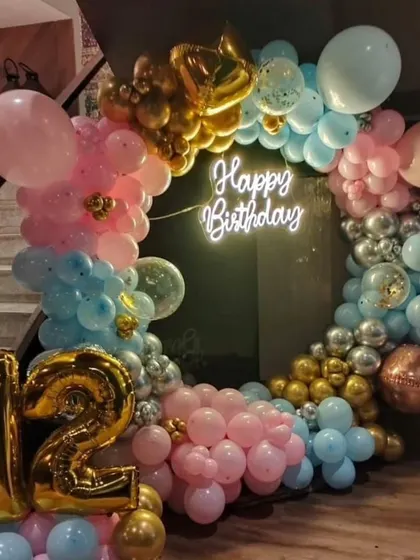 A beautiful pastel-themed 12th birthday. This circular balloon arch in pink, blue, and gold creates a soft and pretty backdrop for a pre-teen celebration.