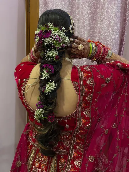 The final look of the bridal hair from the back. This style is not only beautiful but also practical, keeping the hair neatly in place under the dupatta.