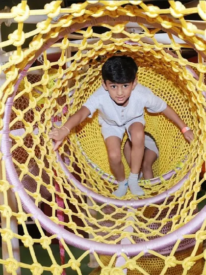 Our play area includes fun tunnels and climbing nets for kids to explore and challenge themselves.