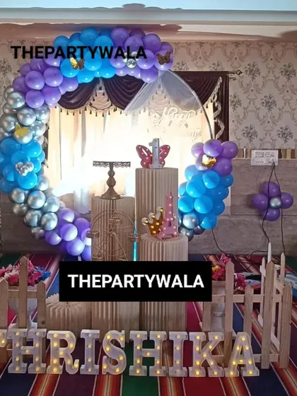 A blue, purple, and silver balloon ring with light-up letters.