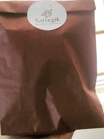 A single package ready for delivery. This simple, sustainable brown paper bag holds freshly made Satvegik goodies, reflecting my commitment to both health and the environment.