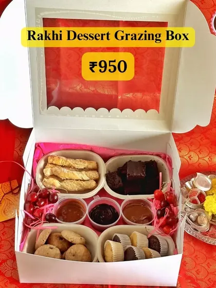 My Rakhi Dessert Grazing Box is the perfect way to celebrate with your sibling. It's filled with an assortment of treats including mini pastries, cookies, brownies, and dips, making for a fun and delicious shared experience.