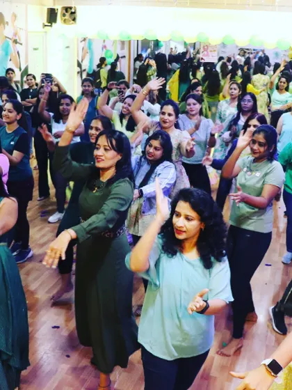 A duplicate image showing the vibrant group of women dancing and celebrating together on Women's Day.