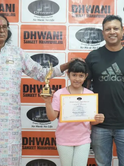 A student with her father and guru, a proud family moment.