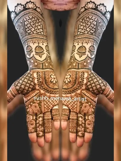 Symmetrical bridal hands with jhumka motifs and heavy jaali work. This is a classic look for a bride who loves traditional mehandi.
