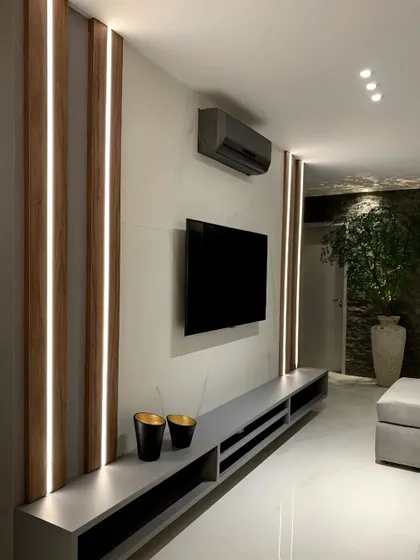 For a minimalist aesthetic, we designed this living space with simple vertical wood accents and an ultra-long, low-profile media console. The design keeps the focus on the clean lines and uncluttered feel of the room.