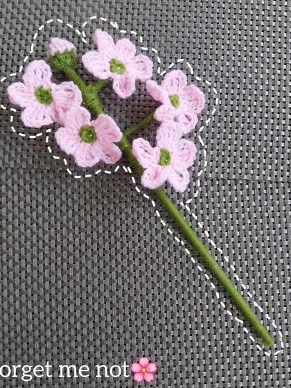 A still shot of the lovely pink forget-me-not crochet flower stick. A unique addition to my floral collection.