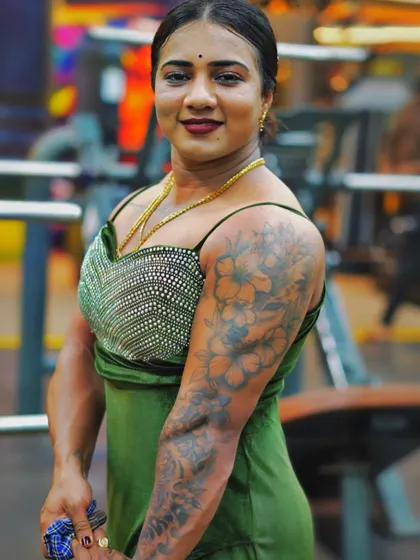 A photo from a gym event, showcasing my physique in a green dress. I always aim to represent strength and confidence.
