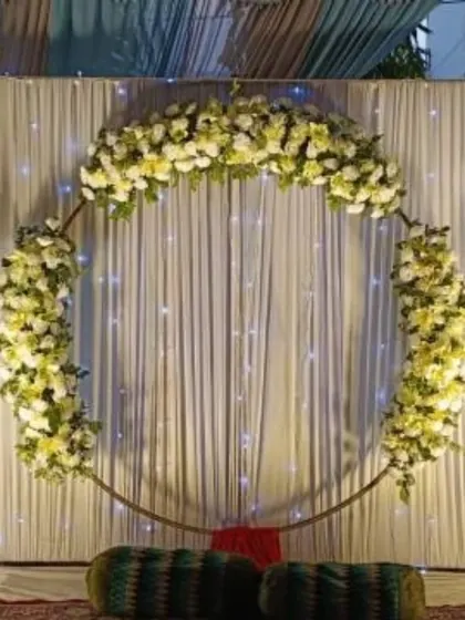 A dreamy engagement stage with a floral ring against a backdrop of fairy lights, perfect for an evening ceremony.