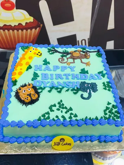 A 1.5kg rectangular jungle theme cake with buttercream animals, perfect for a small party.