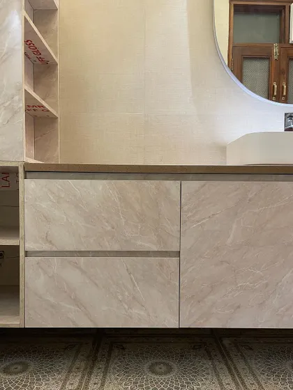 A close-up of the custom vanity, showing the seamless drawers and the beautiful marble-effect laminate finish. The design is both practical and aesthetically pleasing.