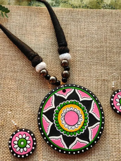The same mandala pendant necklace in a pink, green, and yellow combination.