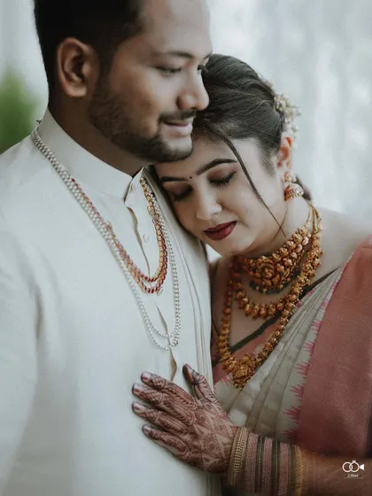 A quiet, intimate portrait from a traditional wedding day. The bride rests her head on her groom's shoulder, a simple gesture that speaks volumes about their comfort and deep connection.