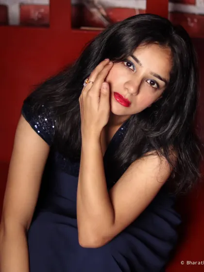A close-up portrait that uses the red studio background to create a warm and intense mood, highlighting the subject's expression.