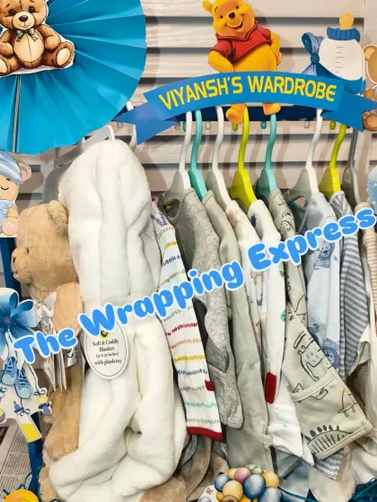 The 'Viyansh's Wardrobe' section of the train, with baby clothes neatly arranged on hangers.