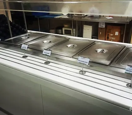 A clean and efficient buffet line setup for a corporate event in Sector 32, Gurgaon. The use of built-in counters ensures a seamless and professional look.