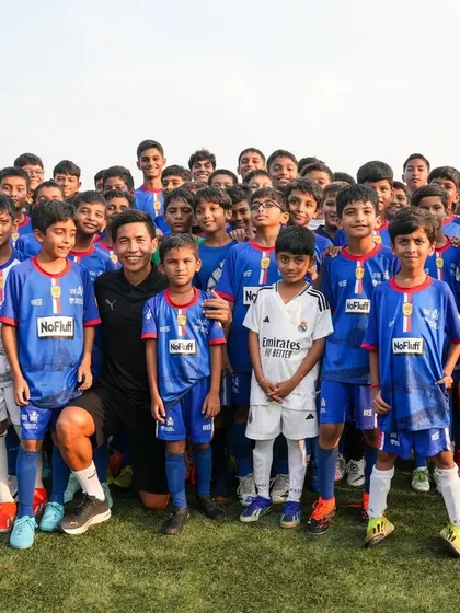 A group of our young players pose for a photo with Assistant Coach Renedy Singh during his visit to the Wings Center.