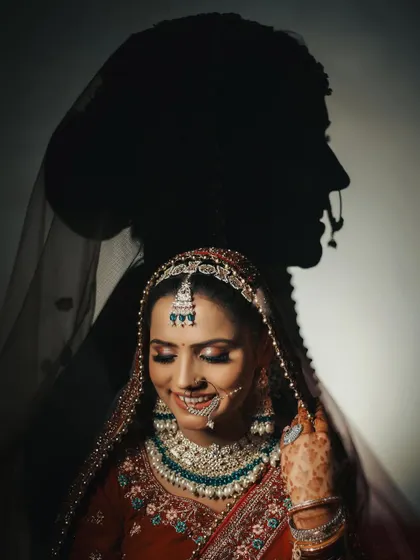 A stunning silhouette portrait of the bride, where her shadow is cast on the wall behind her. This is a highly artistic and memorable shot that stands out in any wedding album.