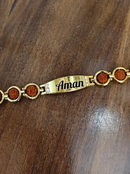 A stylish men's bracelet with rudraksh beads and a personalized nameplate, which also serves as a modern rakhi.