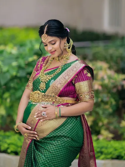 A stunning mom-to-be at her Seemantham, adorned in our classic antique gold temple jewellery. The full set, including the oddiyanam, makes her look like a goddess.