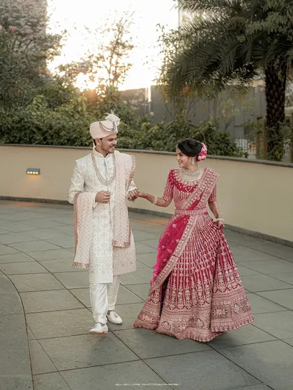 Walking together into their future. This full-length portrait showcases the couple's stunning wedding attire against a clean, modern backdrop at the Sheraton Grand.