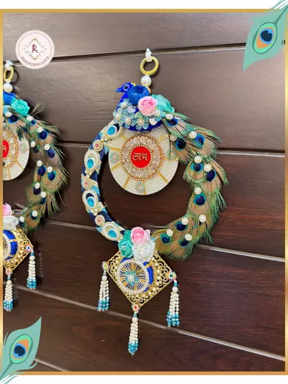 A closer look at the exquisite details of our Peacock Shubh Labh. The real peacock feathers, pearls, and a central 'Shubh' motif create a piece that radiates opulence and auspicious charm.
