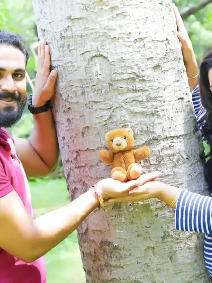 A fun and creative maternity photo with a teddy bear. We love when couples bring props that are meaningful to them for their pregnancy photoshoot.