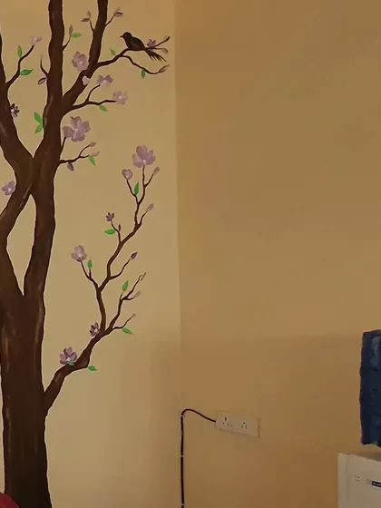A close-up of our cherry blossom wall art. The delicate flowers and branches are hand-painted by our skilled artists to bring a touch of nature's beauty indoors.
