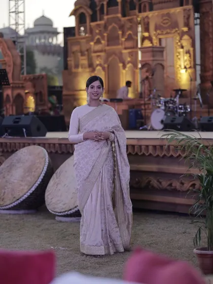 A full-length shot at the "Rising Rajasthan" event, with the magnificent stage setup at Rambagh Palace in the background. The setting itself demanded a certain elegance, and I was honored to be the face of this prestigious evening.