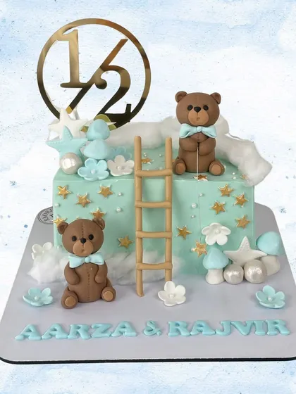 Celebrating a half-birthday for Aarza & Rajvir! This adorable cake features two teddy bears, a ladder to the stars, and a "1/2" topper.