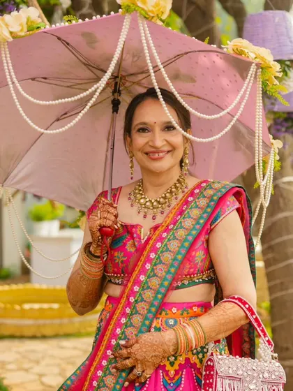 The mother of the bride looks joyful and elegant, ready for the Mehendi ceremony.
