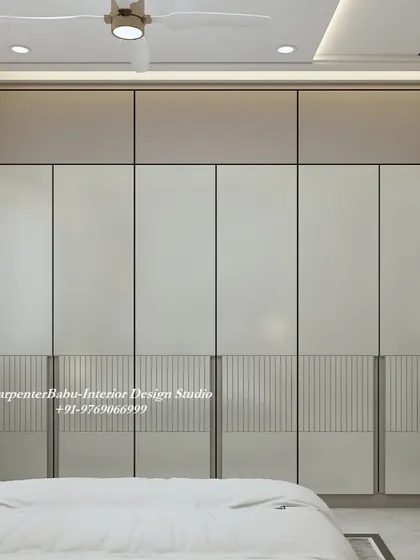 A close-up of the wardrobe, showing the two-tone design and subtle fluted detailing on the lower panels. It's a great example of minimalist design with a touch of texture.