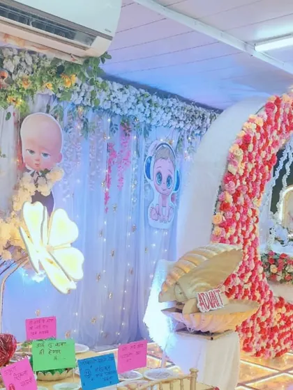 A 'Boss Baby' themed baby shower decoration, combining cartoon fun with elegant floral elements like a flower-covered moon cradle. This shows how I can merge different styles to create a unique look.