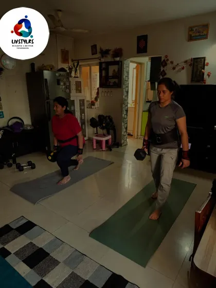 Two clients work on dumbbell lunges, a foundational move for building leg and glute strength. The supportive environment of group training makes the hard work more enjoyable.