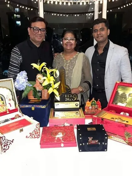 A proud moment for our founders, showcasing the International Iconic Award trophy alongside some of our award-winning invitation box designs. This recognition inspires us to continue crafting beautiful memories for your special occasions.