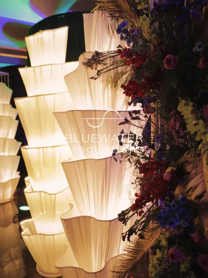 A detailed shot of the custom-made fabric light installations, showing the delicate pleating and warm, diffused glow they create.