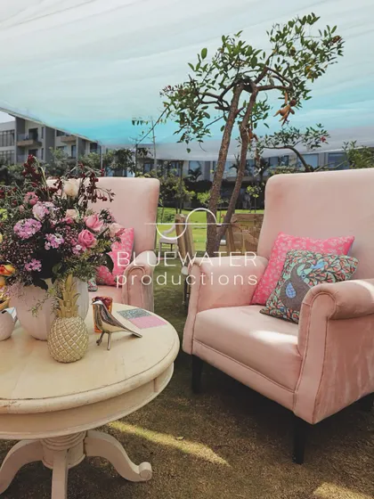 A cozy seating nook under the draped canopy, perfect for a relaxed afternoon event.