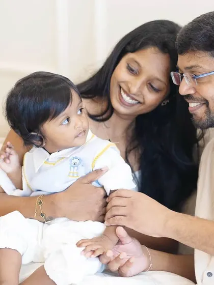 A tender moment between parents and their baby during his first birthday shoot. The studio's soft lighting is perfect for capturing these gentle, intimate family connections.
