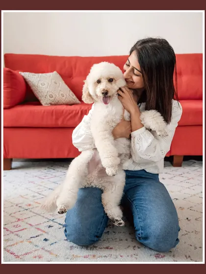 Dinkan gets a loving cuddle from his mom. This photo highlights the affection and comfort pets bring into our homes.