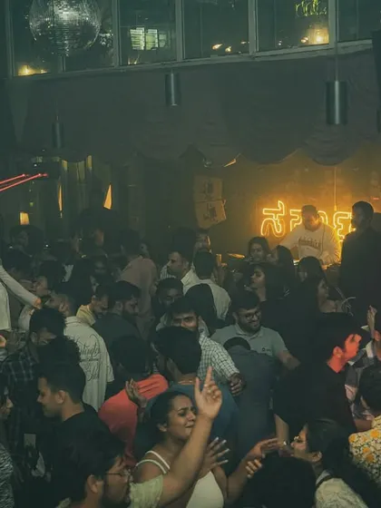 The red laser beams add a dramatic flair to the party at Sarjapur Social.